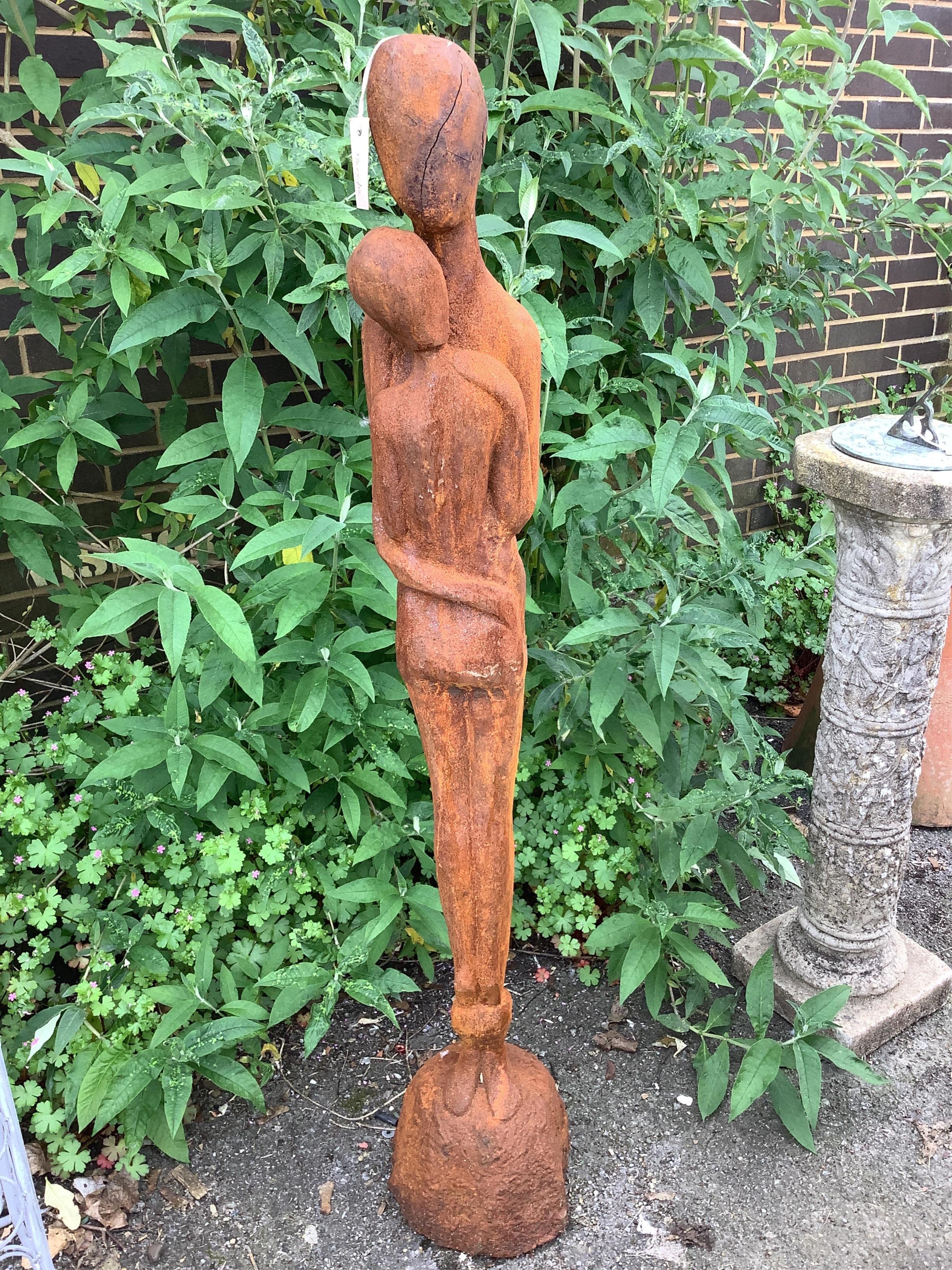 A cast iron embracing couple garden ornament, height 126cm